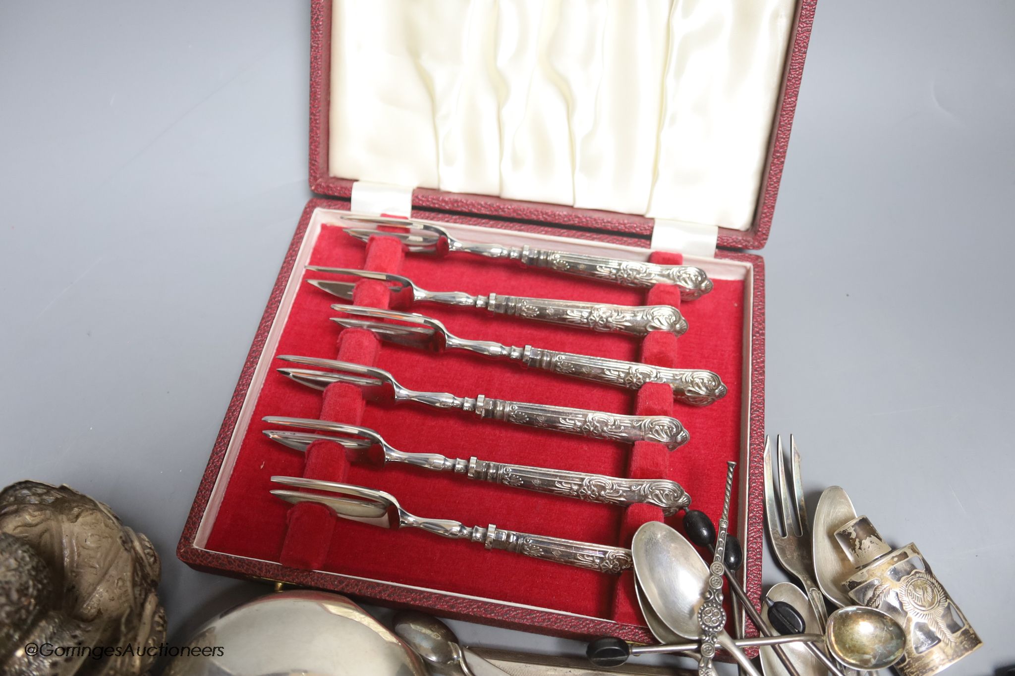 Assorted small silver including a sterling hip flask, cased silver handle tea forks, Art Deco silver cigarette case, teaspoons, tea strainer, overlaid glass scent and three Indian? white metal items, including a pair of